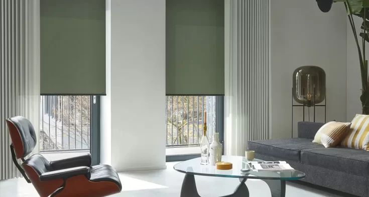Moderne woonkamer met een glazen bijzettafel, witte muren en groene rolgordijnen voor de ramen