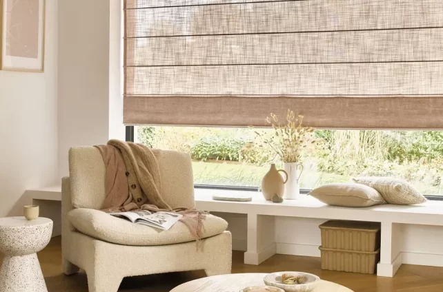 Zithoek met beige meubels en beige vouwgordijnen voor de ramen