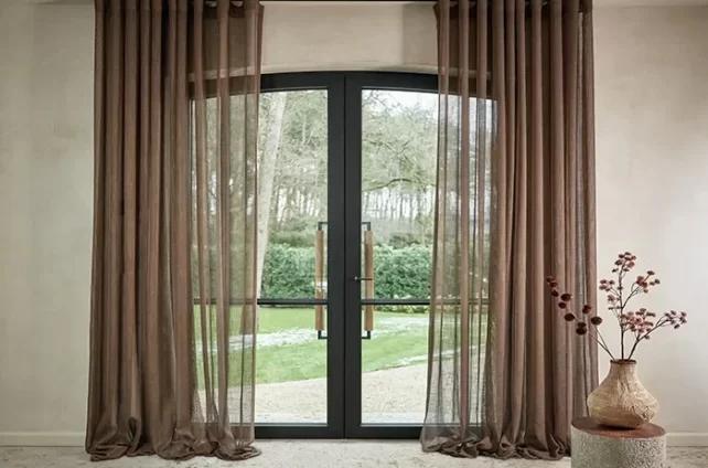 Mooie bruine lichtdoorlatende gordijnen voor grote zwarte glazen deuren