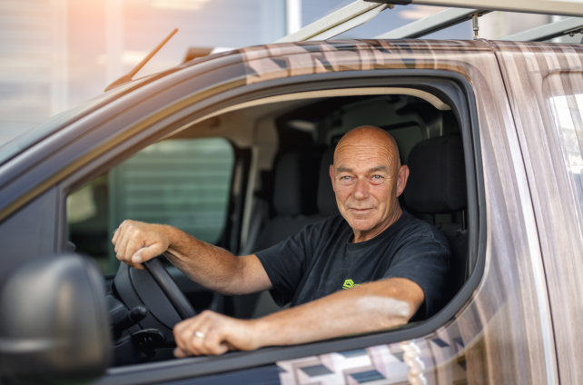 Chauffeur zit in bedrijfswagen van Deventer Zonwering klaar voor installatie op locatie